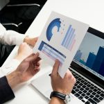 Business professionals discutant de graphiques et de données dans un bureau moderne.