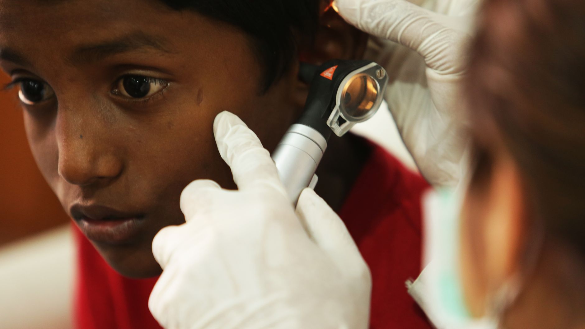 Enfant examiné à l’oreille par un soignant