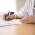 Médecin qui rédige une ordonnance pendant la consultation